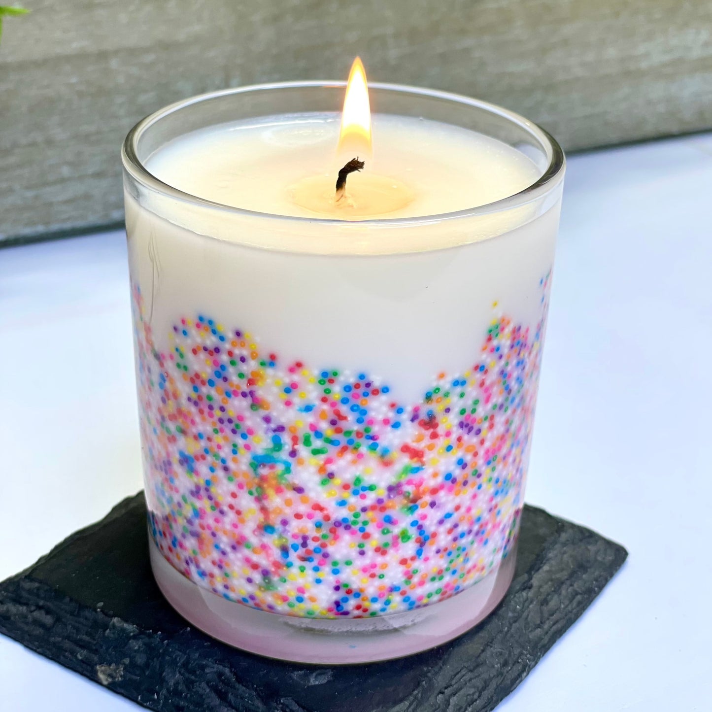 This irresistible birthday cake-scented candle stands tall, adorned with colorful sprinkles, emitting a warm glow. Its handcrafted charm fills the air with nostalgia and joy. Perfectly capturing the spirit of a festive occasion in a delightful aroma. Best birthday candle in Parker Colorado