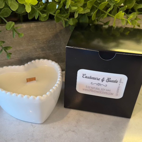 Cashmere Suede soy wax candle in a white heart-shaped reusable bowl with fruity, warm, and earthy notes. 35-hour burn time. Non-toxic and clean.