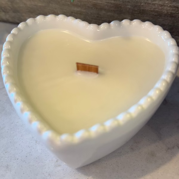 Cashmere Suede soy wax candle in a white heart-shaped reusable bowl with fruity, warm, and earthy notes. 35-hour burn time. Non-toxic and clean.