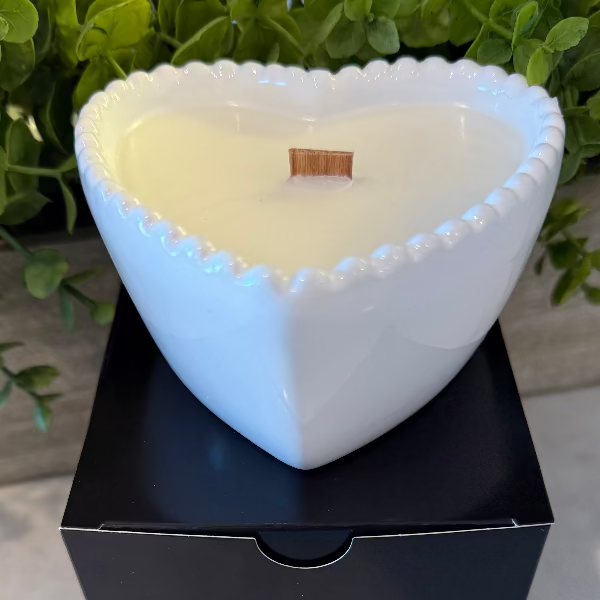 Cashmere Suede soy wax candle in a white heart-shaped reusable bowl with fruity, warm, and earthy notes. 35-hour burn time. Non-toxic and clean.