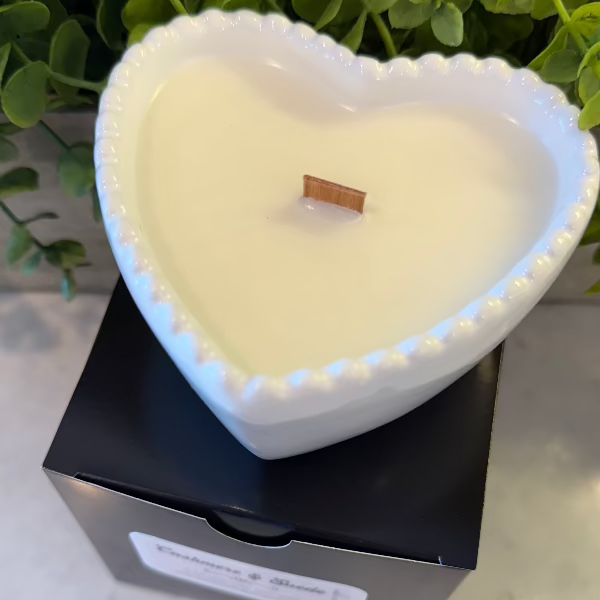 Cashmere Suede soy wax candle in a white heart-shaped reusable bowl with fruity, warm, and earthy notes. 35-hour burn time. Non-toxic and clean.