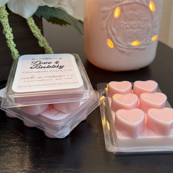 Love & Bubbly soy wax candle melts in heart-shaped containers with sparkling cranberry prosecco scent. 6 melts per package. Long-lasting fragrance.