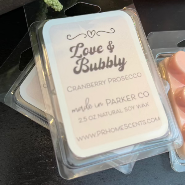 Love & Bubbly soy wax candle melts in heart-shaped containers with sparkling cranberry prosecco scent. 6 melts per package. Long-lasting fragrance.