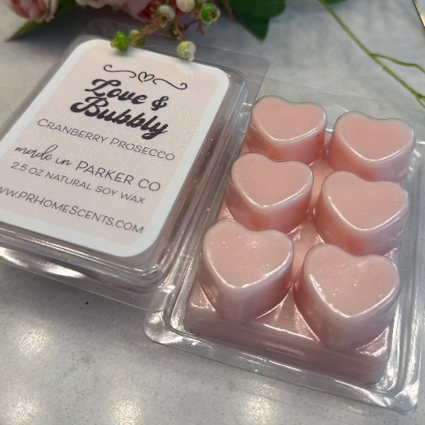 Love & Bubbly soy wax candle melts in heart-shaped containers with sparkling cranberry prosecco scent. 6 melts per package. Long-lasting fragrance.