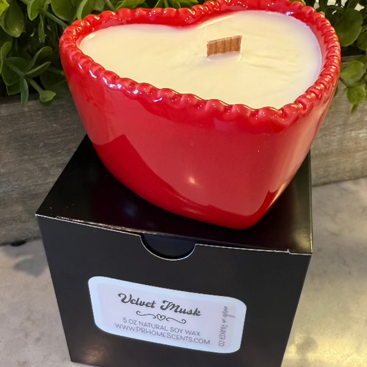 Velvet Musk soy wax candle in a red reusable bowl with citrus, woody, floral, and earthy notes. 35-hour burn time. Clean, non-toxic scent.