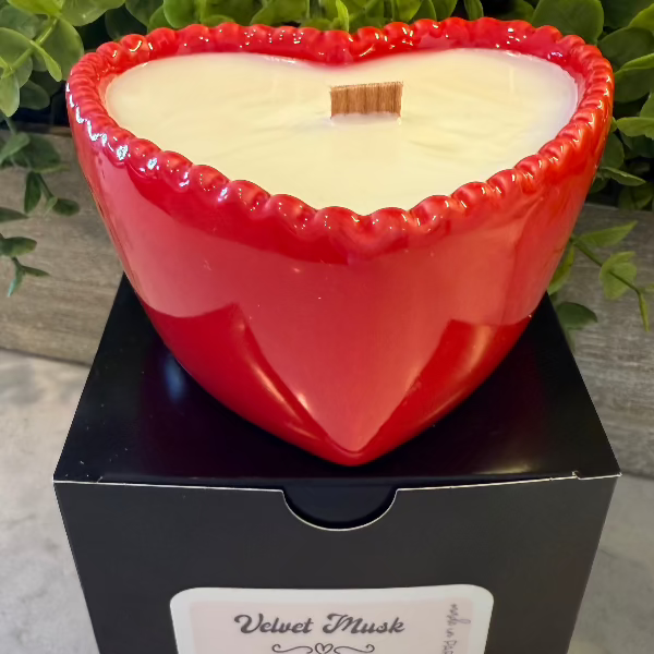 Velvet Musk soy wax candle in a red reusable bowl with citrus, woody, floral, and earthy notes. 35-hour burn time. Clean, non-toxic scent.